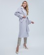Пальто-халат длины миди с клапанами на карманах, рукавом реглан. Дополнено декоративными отстрочками и воротником-стойка с фигурным вырезом. Данная модель красиво подчеркивает женственные формы за счет пояса.

На модели размер XS