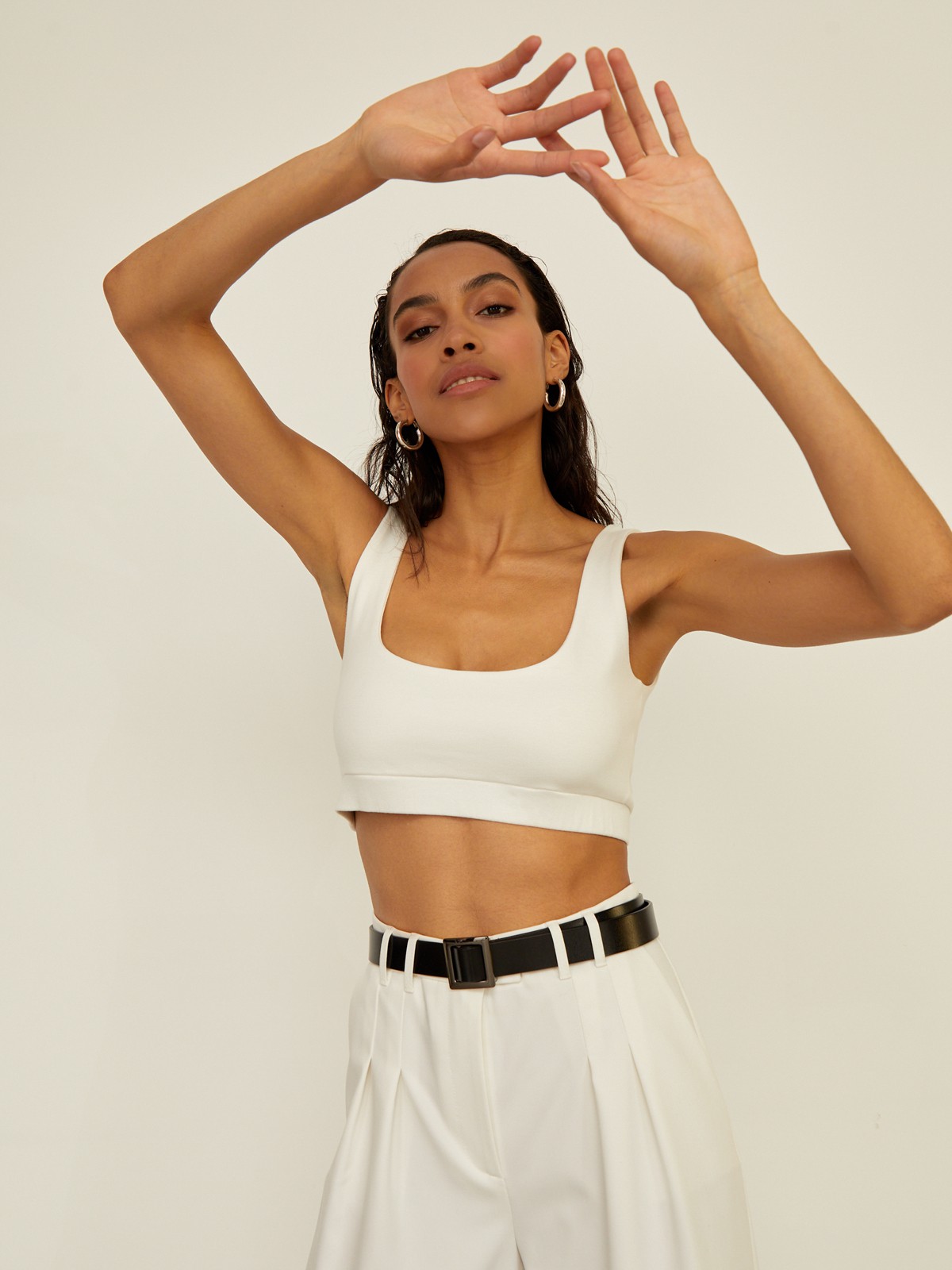 Укороченный топ облегающего кроя выполнен из двухслойной мягкой хлопковой ткани. Ткань топа плотная, что позволит носить его без нижнего белья. Квадратный вырез и широкие бретели подчеркивают плечи и линию декольте.

На модели размер XS