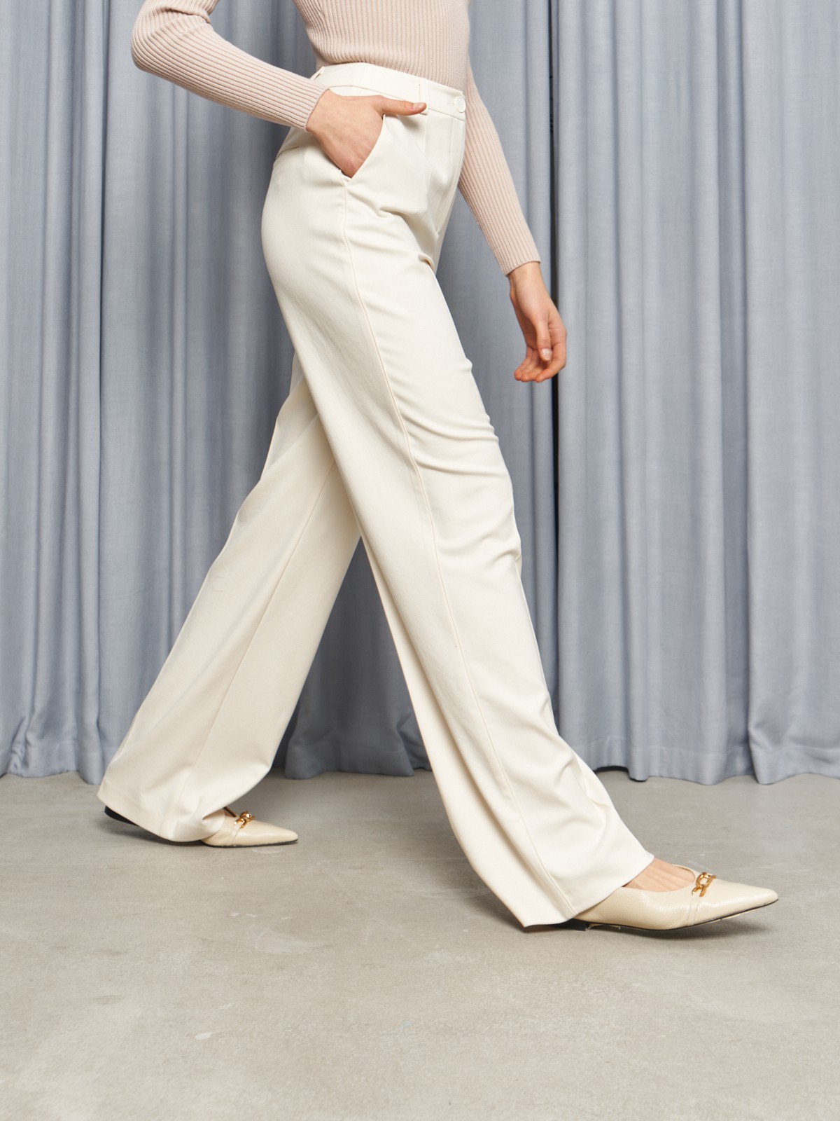 Костюмные брюки прямого кроя оформлены кантиком и продольными стрелками, вытягивающими силуэт. Пришивной пояс со шлевками на талии.

На модели размер XS