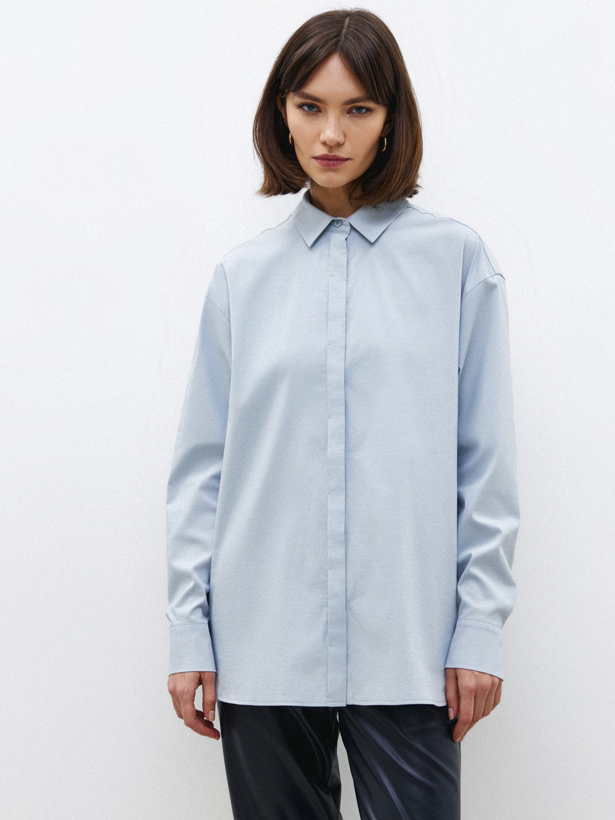 Рубашка oversize, цвет: серо-голубой Allweneed Рубашка oversize кроя с отложным воротником изастежкой на пуговицы. Длинные рукава с классическими манжетами. Слегка удлиненная спинка. Носите навыпуск или заправленной в контрастную юбку, шорты или брюки.