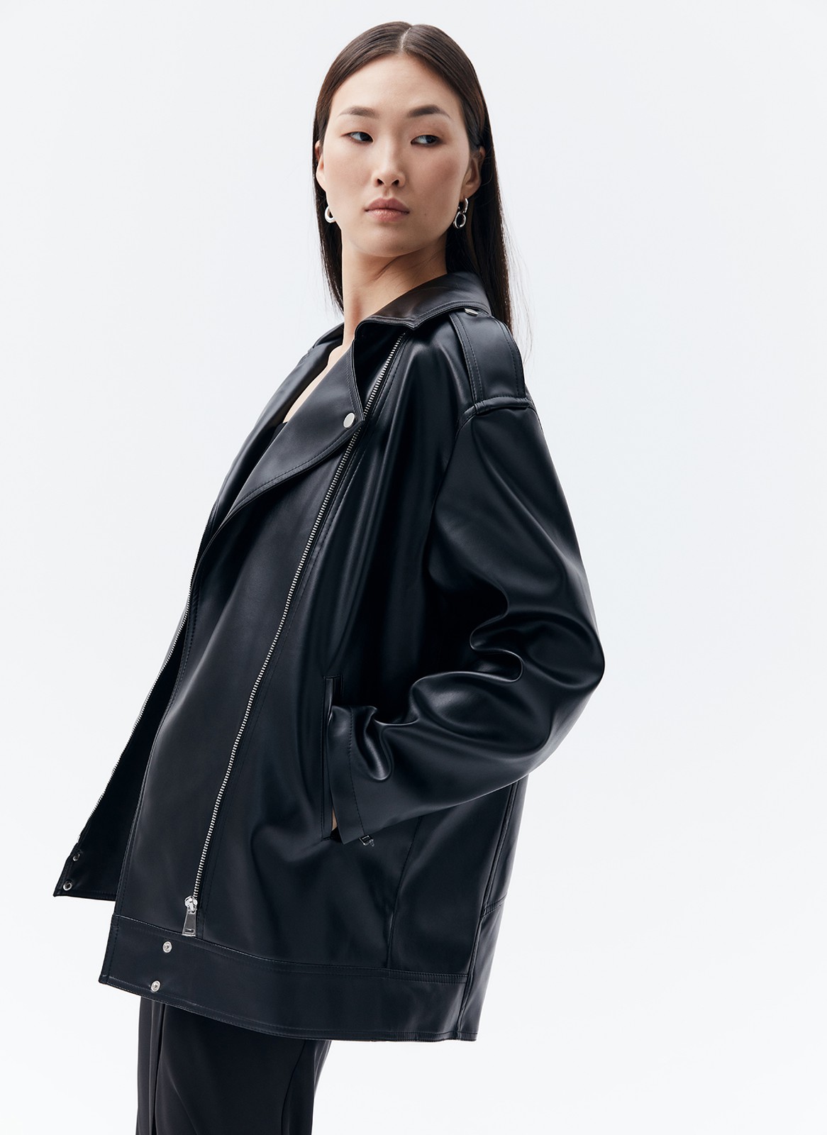 Куртка-косуха oversize из экокожи, цвет: черный №2 Allweneed Удлиненная куртка-косуха актуальна во все времена. Модель oversize выполнена из плотной и качественной экокожи. Куртка с широким воротником и двумя удобными карманами. Мы добавили металлическую фурнитуру и погоны. Классическая косая застежка и застежка-молния на рукавах. Рабочие кнопки на поясе и две декоративные кнопки на лацканах. Мы любим ее носить с джинсами и рубашкой. Три базовых цвета: чёрный, кэмел и молочный с черной фурнитурой.