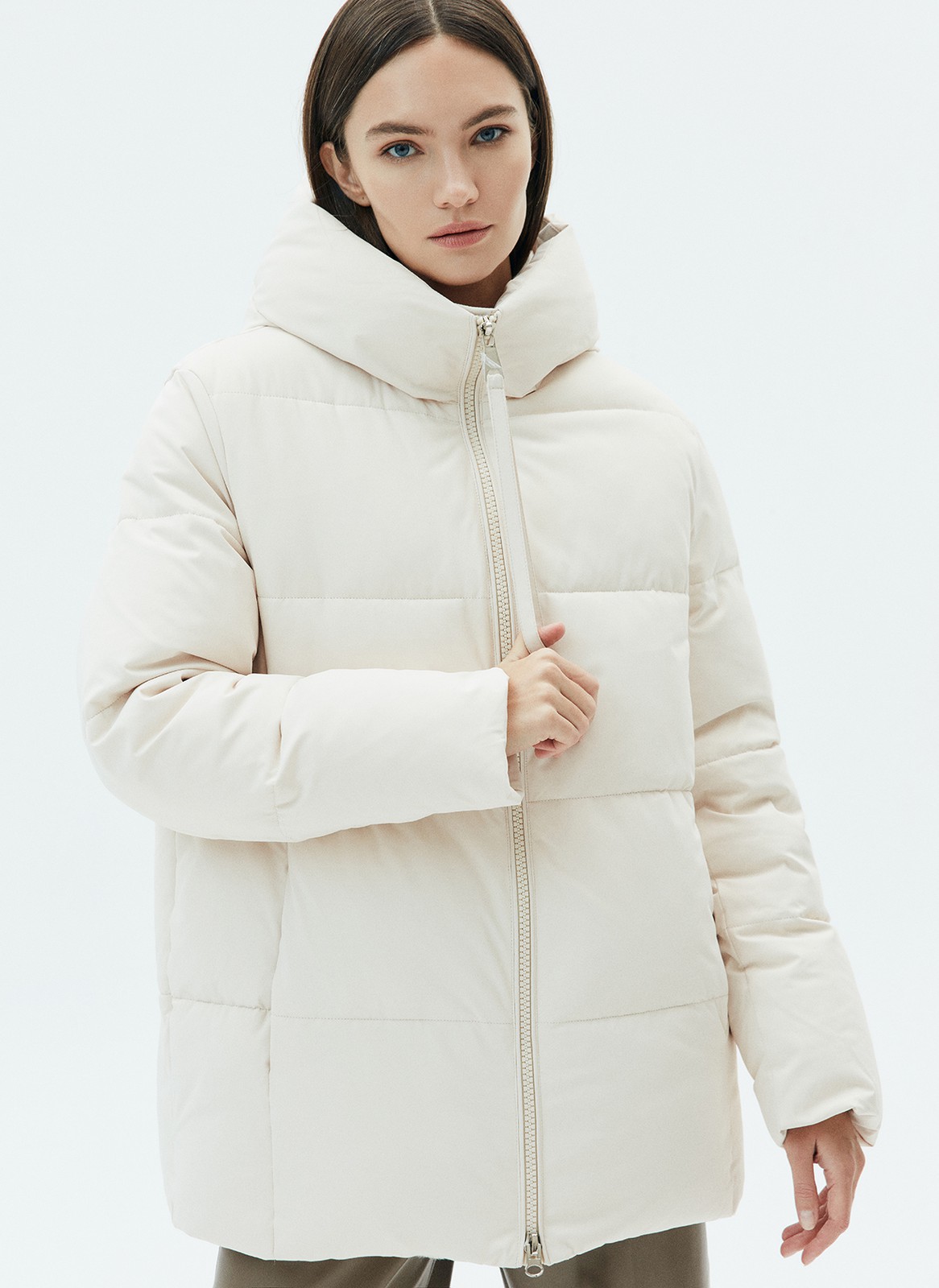 ПУХОВИК OVERSIZE КОРОТКИЙ, цвет: светло-бежевый Allweneed Удобная застежка на молнию и высокое горло, чтобы вам было тепло на прогулке. Модель прямого кроя, поэтому хорошо садится на любую фигуру. В куртке комфортно и тем, кто проводит много времени за рулем. Сочетайте с любой зимней обувью: ботинками и сапогами. Держит тепло до - 25.