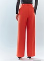 Брюки широкие полной длины, цвет: коралловый Allweneed Брюки на средней посадке полной длины. Скрытая застёжка на молнию. Модель свободного кроя делает силуэт визуально стройнее. Приятная к телу костюмная ткань хорошо держит форму и обеспечивает правильную посадку по фигуре. Мы рекомендуем сочетать брюки с жакетом из новогодней коллекции, дополняя комплект броскими украшениями в праздничную ночь и топом в рубчик в будничной жизни. Представлены в трёх цветах: сиреневый рассказывает о тихом утре 1 января, красный апельсин символизирует мандарины и гирлянды, а белый это чистый зимний снег.