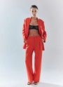 Брюки широкие полной длины, цвет: коралловый Allweneed Брюки на средней посадке полной длины. Скрытая застёжка на молнию. Модель свободного кроя делает силуэт визуально стройнее. Приятная к телу костюмная ткань хорошо держит форму и обеспечивает правильную посадку по фигуре. Мы рекомендуем сочетать брюки с жакетом из новогодней коллекции, дополняя комплект броскими украшениями в праздничную ночь и топом в рубчик в будничной жизни. Представлены в трёх цветах: сиреневый рассказывает о тихом утре 1 января, красный апельсин символизирует мандарины и гирлянды, а белый это чистый зимний снег.