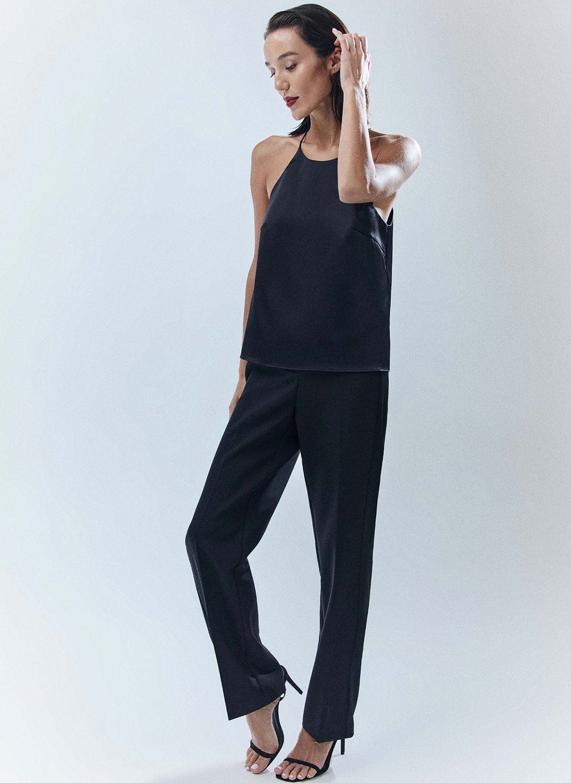 Топ на тонких бретелях в бельевом стиле. Модель выполнена из ткани с деликатным отливом, чтобы сиять под светом праздничных огней. На изделии есть специальные вытачки для лучшей посадки. Мы создали модель с трендовым вырезом халтер. Сочетайте с любимой юбкой или брюками из новогодней капсулы, а также носите после праздников и даже летом топ получился довольно универсальным.

