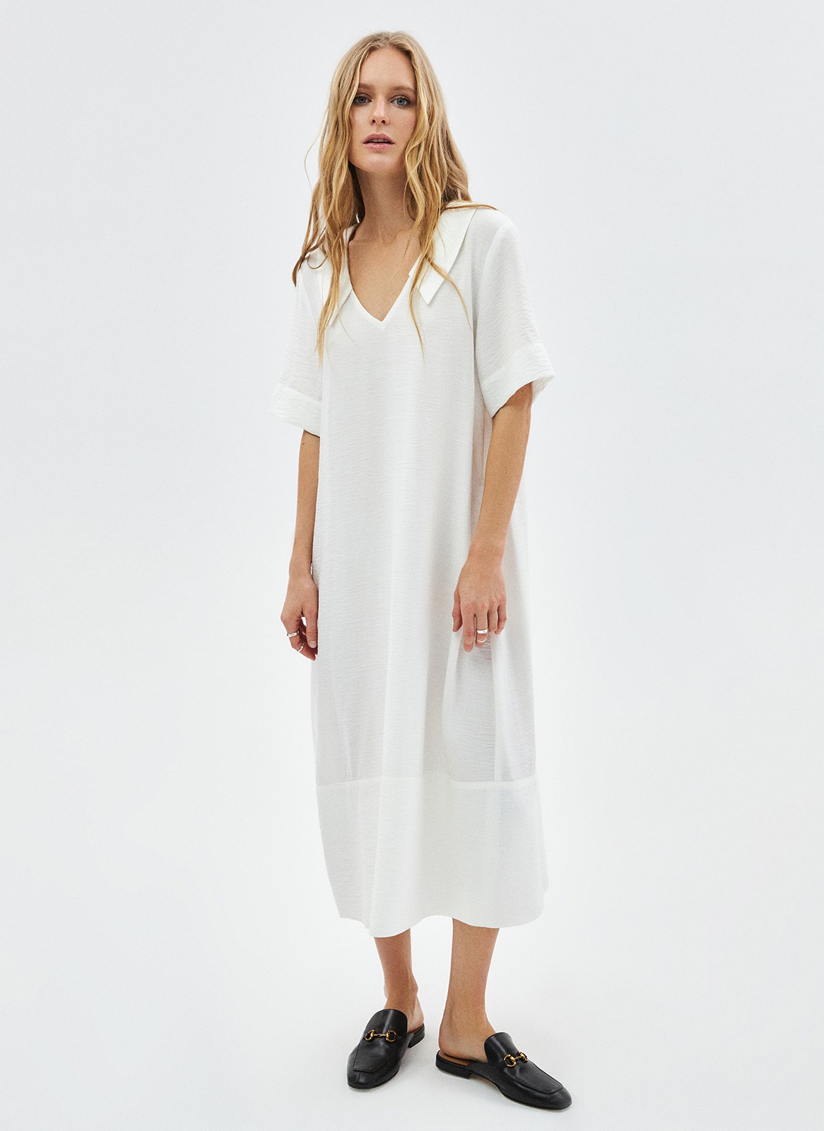 Платье объемное миди с воротником, цвет: молочный Allweneed Объёмное платье длины миди. Модель с отложным воротником и короткими широкими рукавами. V-образный вырез подчёркивает красоту зоны декольте и ключиц. На платье внизу есть отрезная деталь, которая помогает сохранить объём юбки. Мы добавили к платью дополнительно пояс, чтобы можно было сделать акцент на талии. Приятная к телу фактура. Сочетайте модель с любимым ботинками, туфлями или с босоножками в жаркое время.