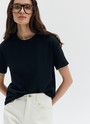 Футболка из эластичного, мягкого хлопка. Базовая модель свободного кроя со спущенным плечом. Благодаря материалу в футболке комфортно целый день идеально для жаркого времени года. Носите с джинсами, юбками и брюками.